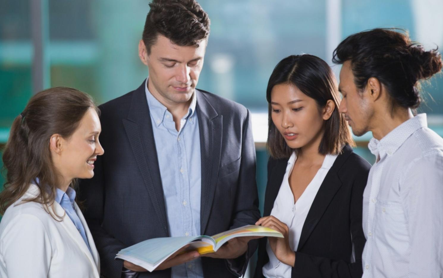 Person reviewing financial statements with laptop and papers
