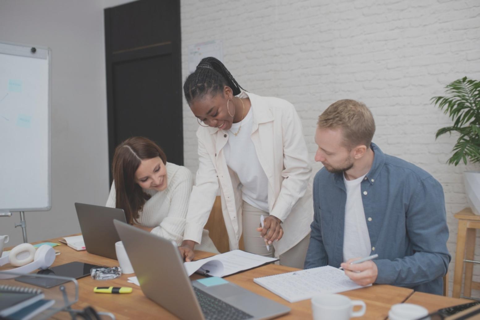 Couple reviewing financial documents together with laptop